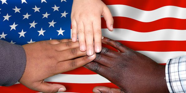 Flag with black, white, and brown hands on top